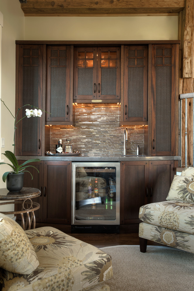 Inspiration for a medium sized classic single-wall wet bar in Detroit with a submerged sink, shaker cabinets, dark wood cabinets, stainless steel worktops, beige splashback, matchstick tiled splashback and dark hardwood flooring.