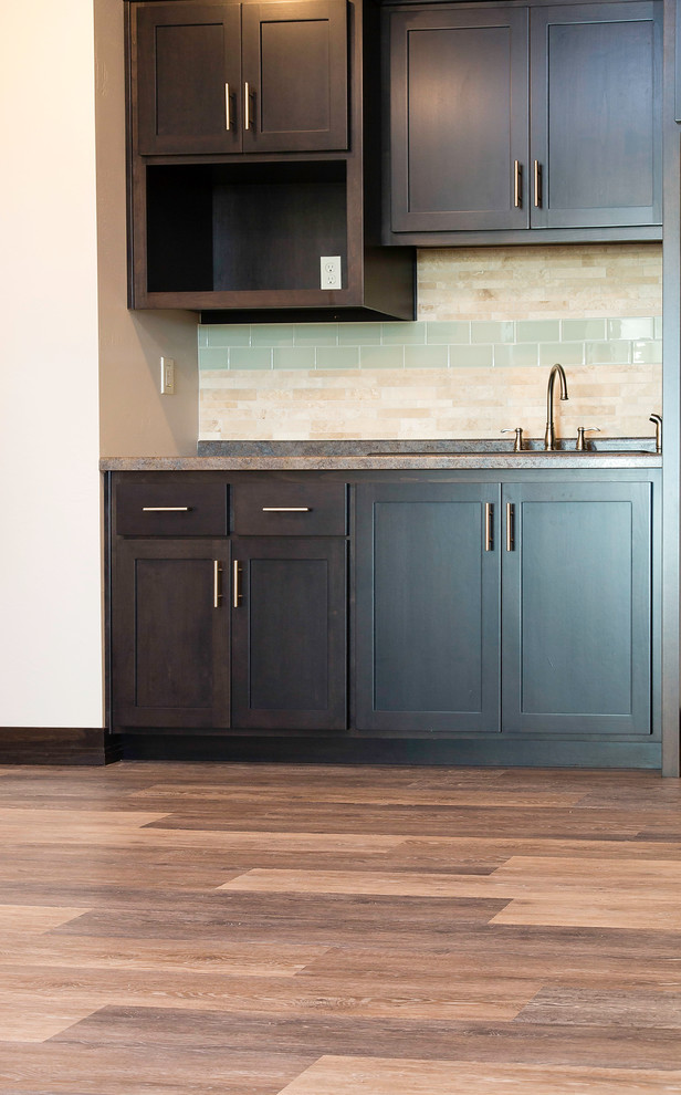 Example of a mid-sized classic vinyl floor and brown floor wet bar design in Other with medium tone wood cabinets, multicolored backsplash and glass tile backsplash
