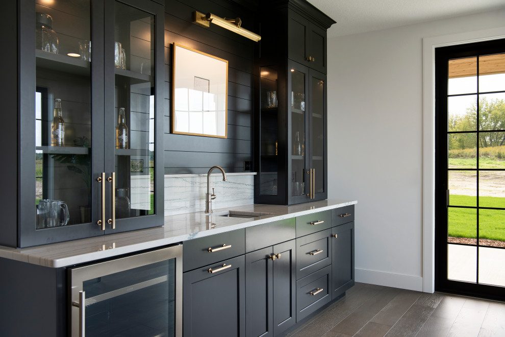 Transitional home bar photo in Minneapolis with glass-front cabinets, gray cabinets, gray backsplash and gray countertops