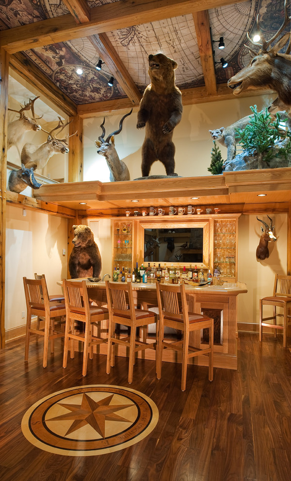 Photo of a medium sized rustic breakfast bar in New York with medium wood cabinets and dark hardwood flooring.