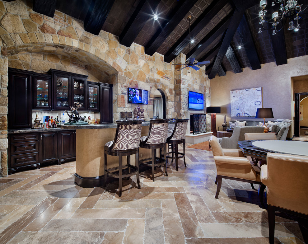 Mediterranean l-shaped breakfast bar in Houston with glass-front cabinets and dark wood cabinets.