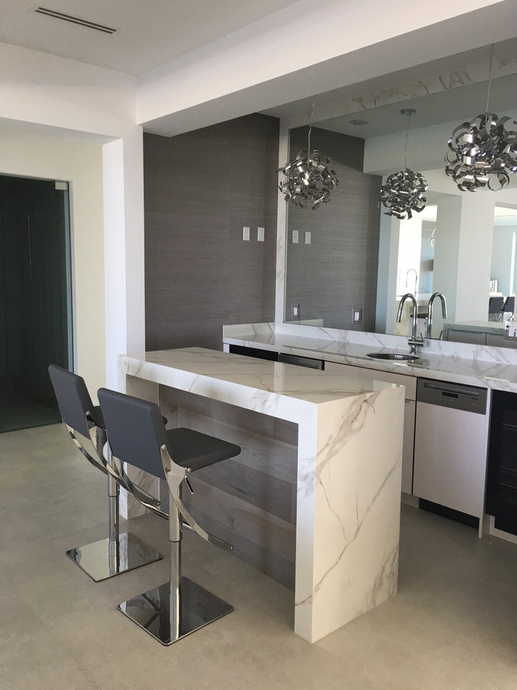 Medium sized contemporary galley wet bar in Miami with a submerged sink, flat-panel cabinets, white cabinets, quartz worktops and mirror splashback.