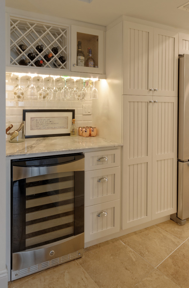 Small traditional single-wall wet bar in Miami with beaded cabinets, white cabinets, marble worktops, white splashback, ceramic splashback and ceramic flooring.