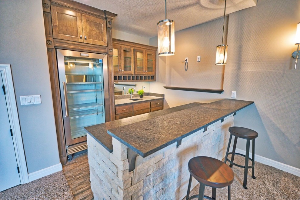 Mid-sized transitional single-wall dark wood floor and brown floor seated home bar photo in Kansas City with an undermount sink, recessed-panel cabinets, medium tone wood cabinets, granite countertops, mirror backsplash and gray countertops
