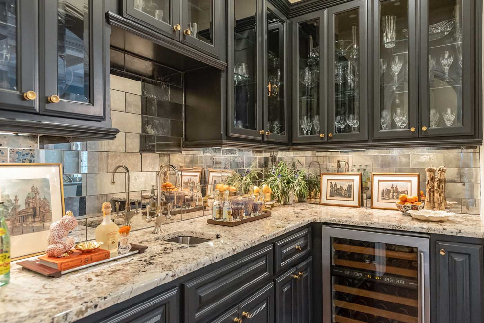 Photo of a large classic l-shaped wet bar in Austin with a submerged sink, recessed-panel cabinets, black cabinets, granite worktops, mirror splashback and dark hardwood flooring.