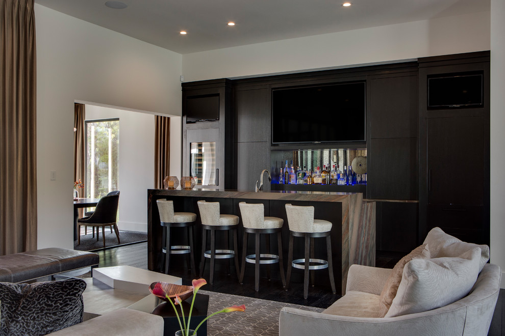 Photo of a large contemporary single-wall breakfast bar in Orlando with flat-panel cabinets, black cabinets, granite worktops, mirror splashback and brown worktops.