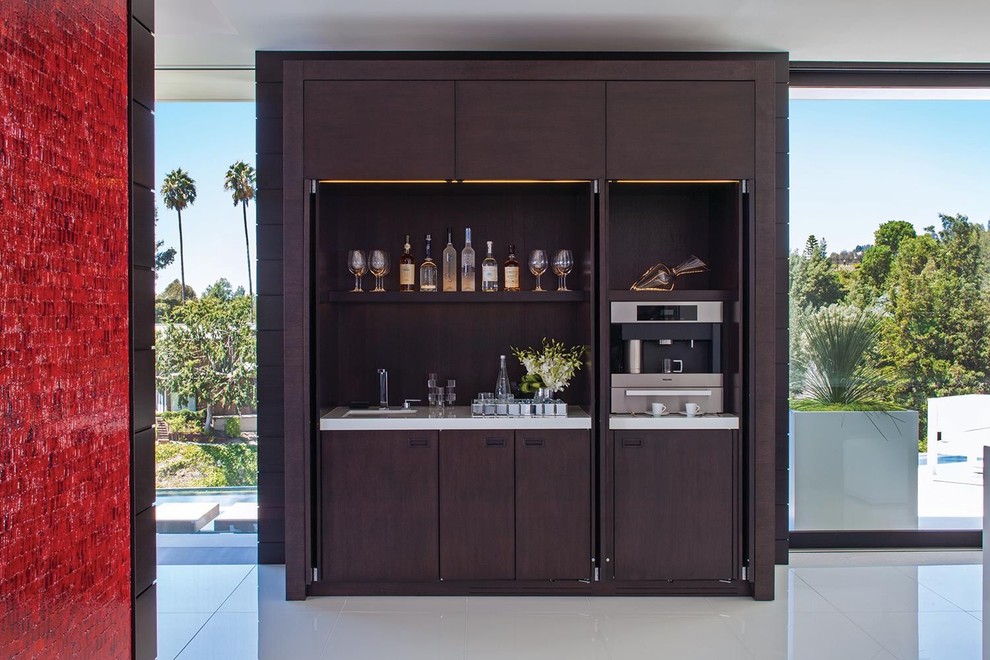 Inspiration for a contemporary single-wall wet bar in Los Angeles with flat-panel cabinets and dark wood cabinets.