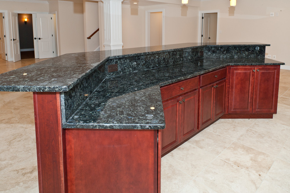 This is an example of an expansive classic breakfast bar in DC Metro with a submerged sink, raised-panel cabinets, dark wood cabinets, granite worktops and marble flooring.
