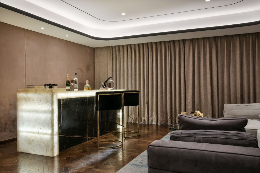 Seated home bar - mid-sized contemporary single-wall brown floor seated home bar idea in Mumbai with flat-panel cabinets, black cabinets and beige countertops