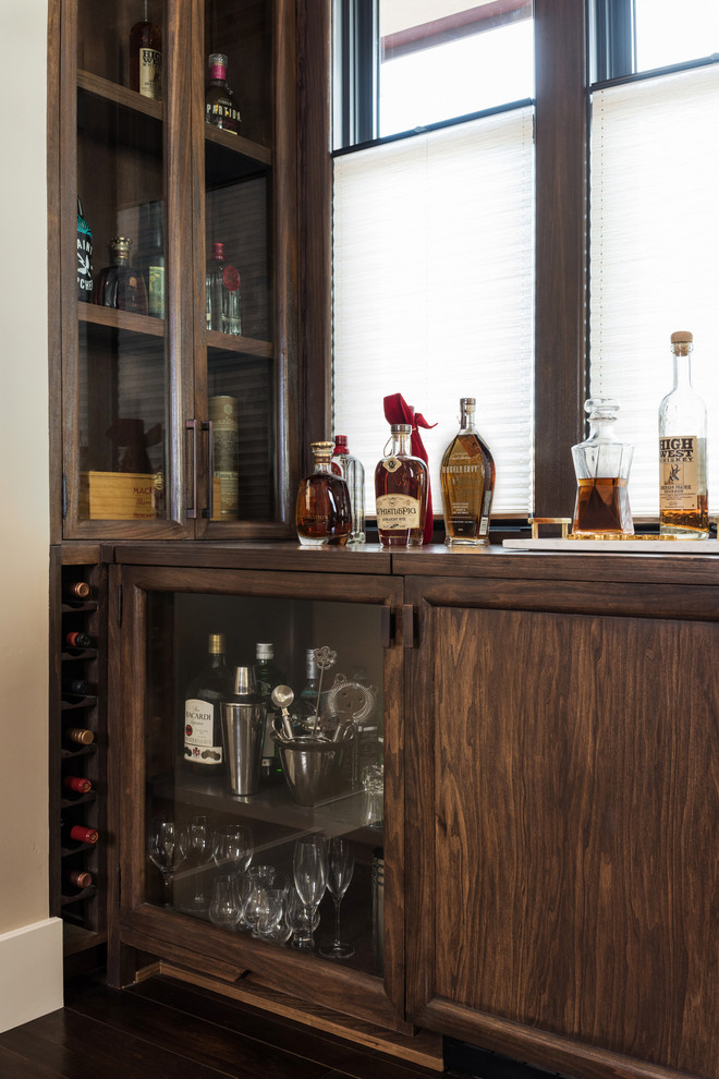 Medium sized traditional single-wall wet bar in San Diego with raised-panel cabinets, dark wood cabinets, wood worktops, dark hardwood flooring and brown floors.