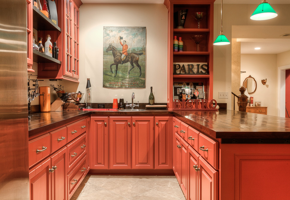 Inspiration for a traditional u-shaped home bar in Kansas City with a built-in sink, raised-panel cabinets and red cabinets.
