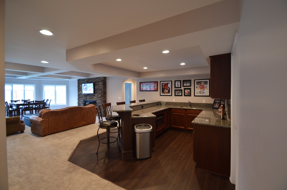 Home bar - traditional vinyl floor home bar idea in Detroit with granite countertops and stone tile backsplash