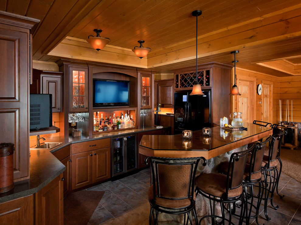 This is an example of a rustic l-shaped breakfast bar in Other with a built-in sink, raised-panel cabinets, dark wood cabinets, composite countertops and ceramic flooring.