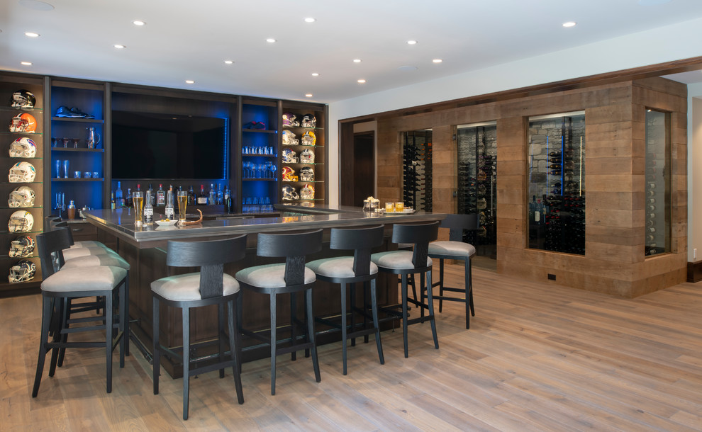 This is an example of a rustic breakfast bar in Minneapolis with open cabinets, dark wood cabinets, light hardwood flooring and grey worktops.