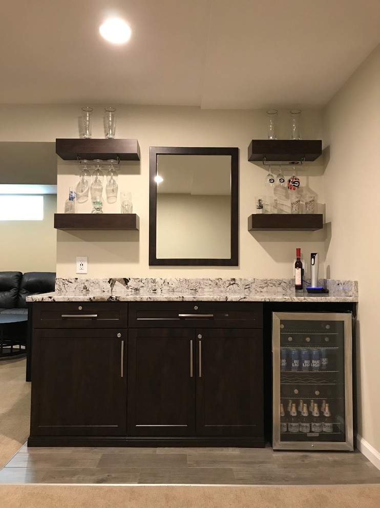 Traditional wet bar in Indianapolis with shaker cabinets, dark wood cabinets and granite worktops.