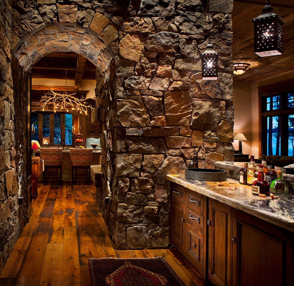 Inspiration for a rustic home bar in Other with dark hardwood flooring, recessed-panel cabinets and dark wood cabinets.