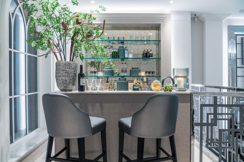 Seated home bar - contemporary seated home bar idea in Berkshire with open cabinets and mirror backsplash