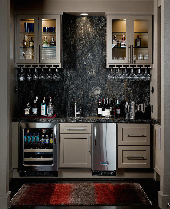 Inspiration for a mid-sized modern single-wall dark wood floor home bar remodel in Houston with an undermount sink, shaker cabinets, beige cabinets, granite countertops, gray backsplash and stone slab backsplash