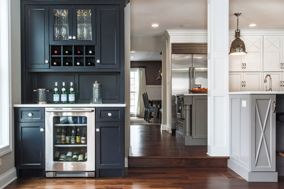 Photo of a medium sized classic single-wall wet bar in Chicago with recessed-panel cabinets, dark hardwood flooring and brown floors.