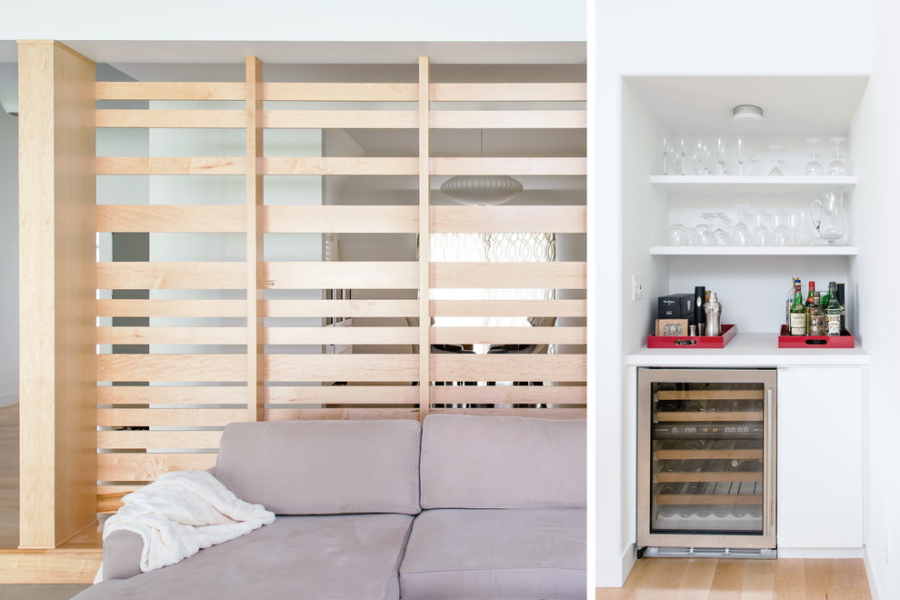Inspiration for a mid-sized mid-century modern single-wall light wood floor wet bar remodel in Orange County with no sink, white cabinets, quartz countertops, white backsplash and open cabinets