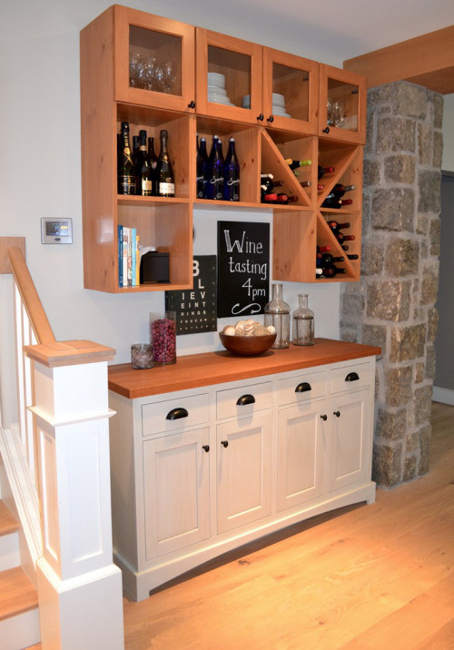 Design ideas for a small traditional single-wall wet bar in Boston with shaker cabinets, white cabinets, light hardwood flooring and beige floors.
