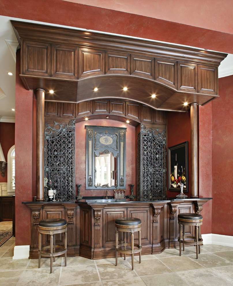 Large victorian home bar in Charlotte with raised-panel cabinets and dark wood cabinets.