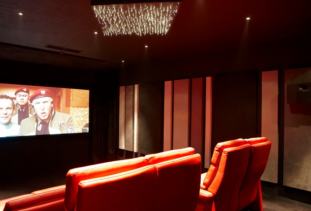 This is an example of a large contemporary enclosed home cinema in Berkshire with black walls, carpet and a built-in media unit.