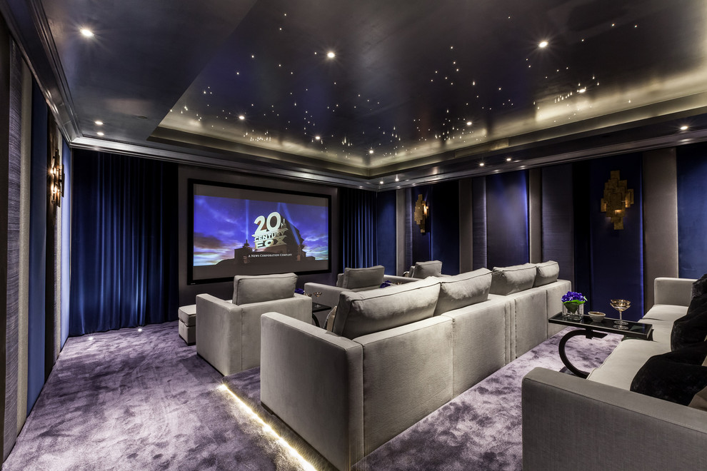 Large contemporary enclosed home cinema in London with multi-coloured walls, carpet and a projector screen.