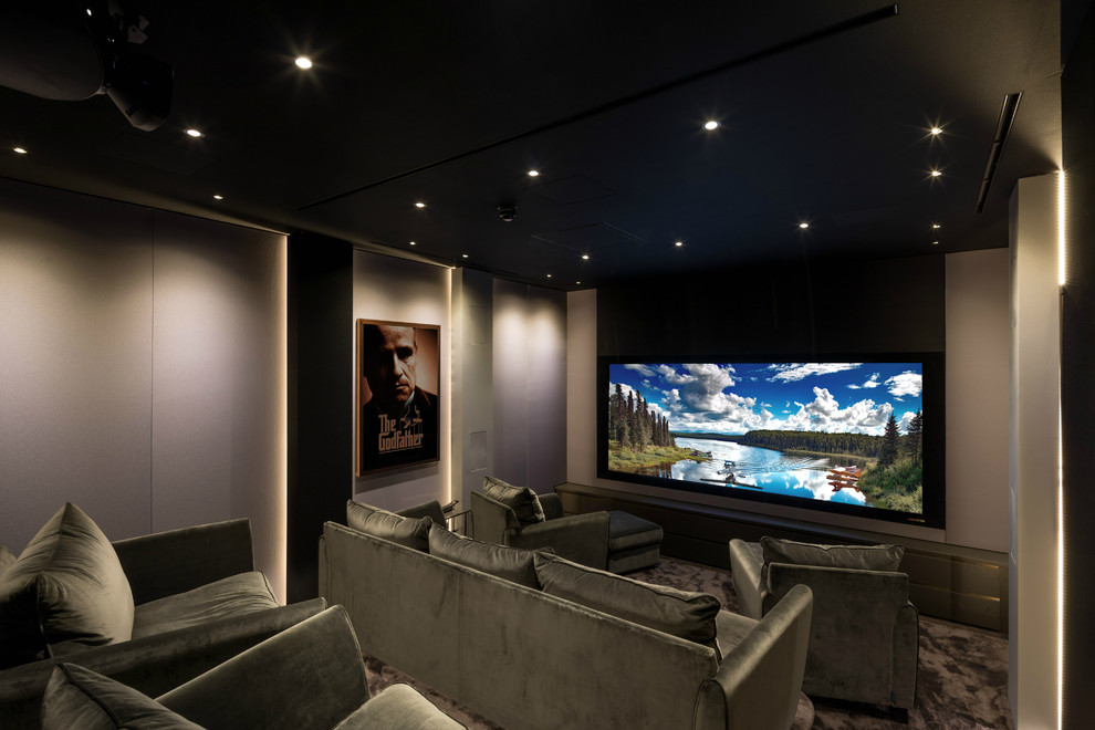 Inspiration for a medium sized contemporary enclosed home cinema in Cambridgeshire with grey walls, carpet, a projector screen and grey floors.