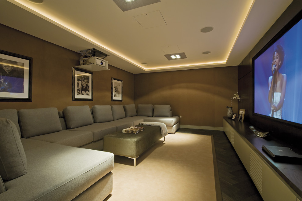 Home theater - contemporary home theater idea in London with brown walls