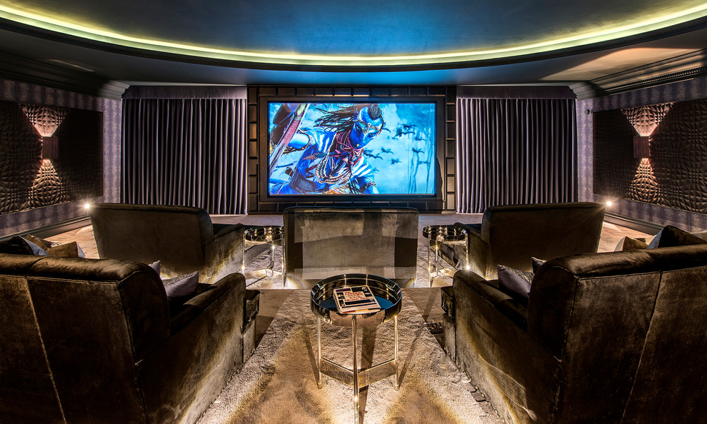 Photo of a large modern enclosed home cinema in Surrey with purple walls, carpet, a projector screen and grey floors.