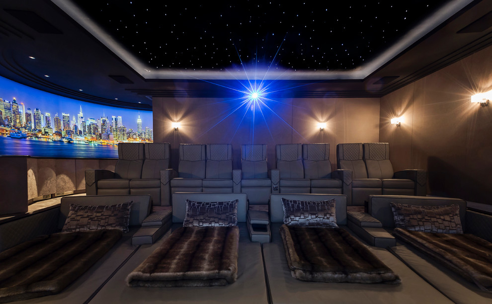 Large contemporary enclosed home cinema in Berkshire with brown walls, carpet and a projector screen.