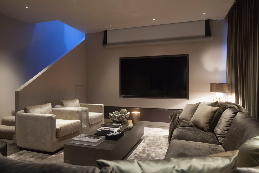 This is an example of a large contemporary open plan home cinema in West Midlands with grey walls, ceramic flooring and a projector screen.