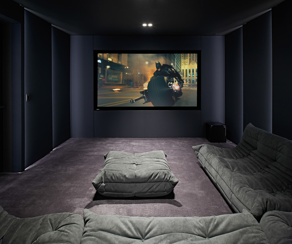 Medium sized contemporary enclosed home cinema in Dorset with purple walls, carpet, a projector screen and grey floors.