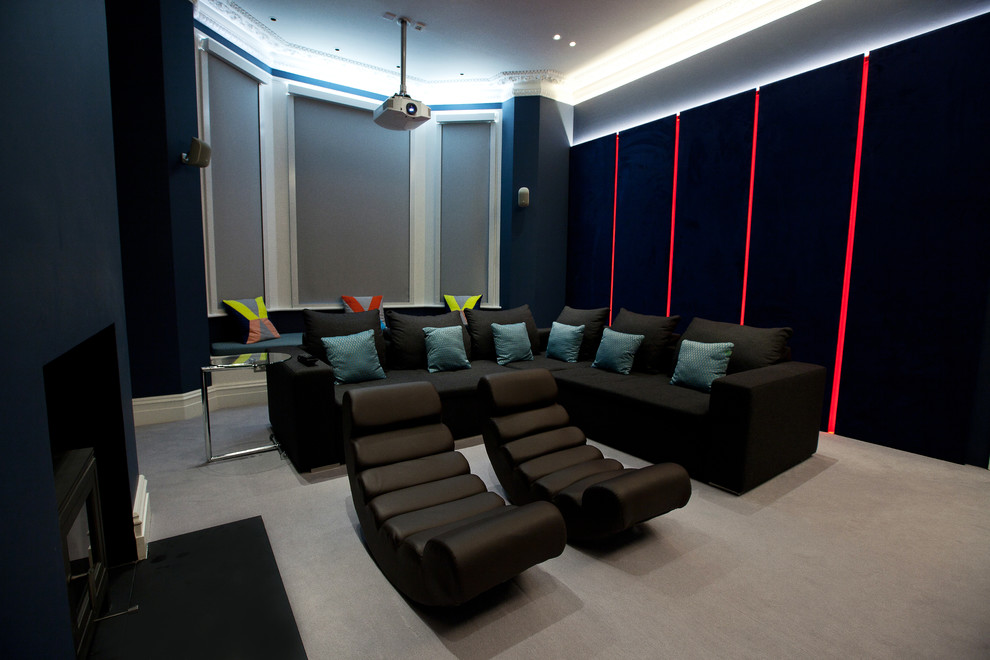 Example of a mid-sized trendy enclosed carpeted home theater design in London with blue walls and a projector screen