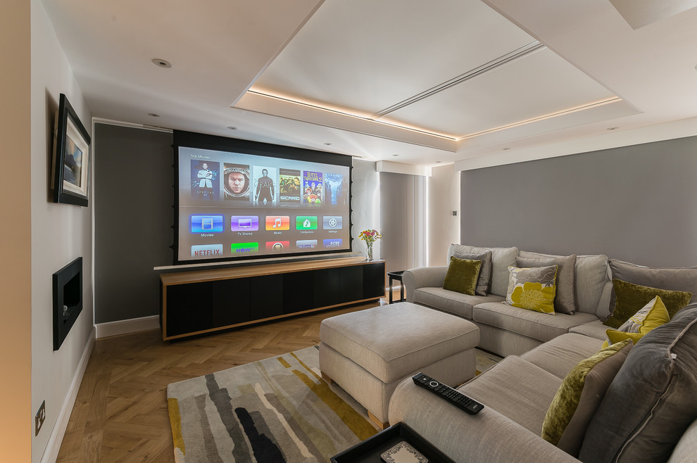 Inspiration for a medium sized contemporary home cinema in Kent with beige walls, carpet and a projector screen.