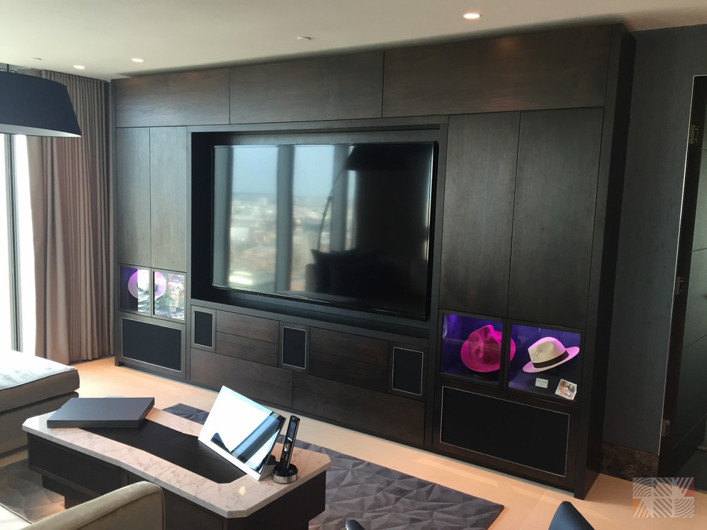 This is an example of a medium sized contemporary enclosed home cinema in London with marble flooring, a built-in media unit and blue walls.