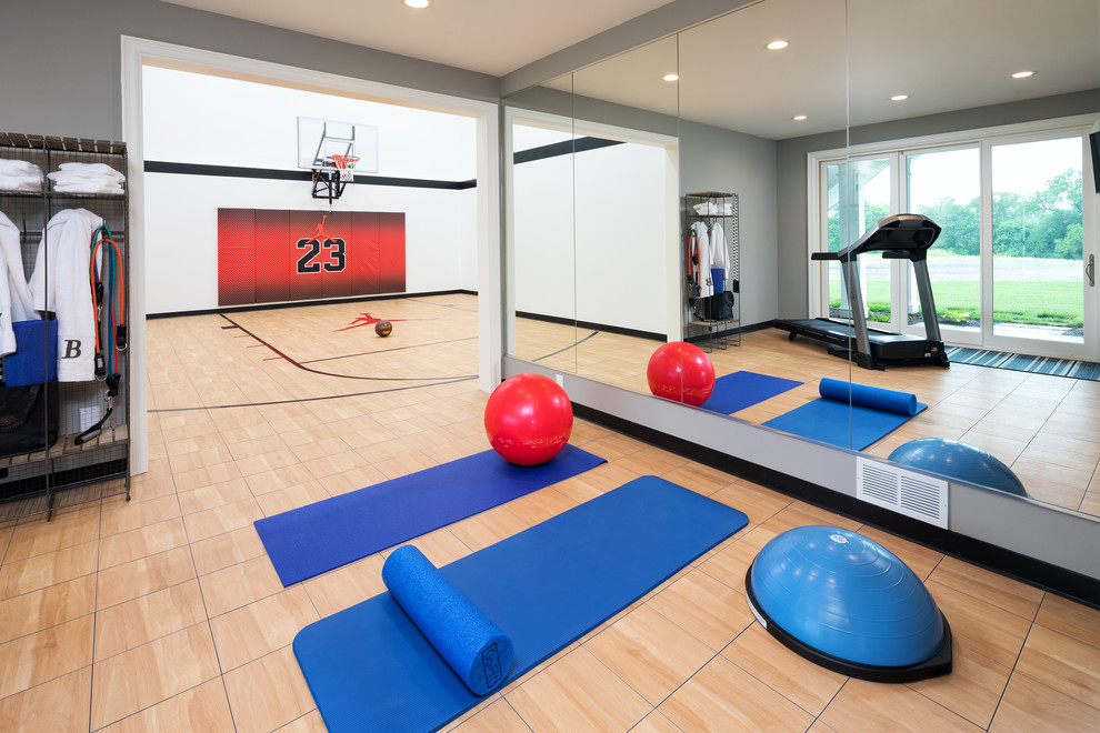 This is an example of a traditional indoor sports court in Minneapolis with white walls and brown floors.