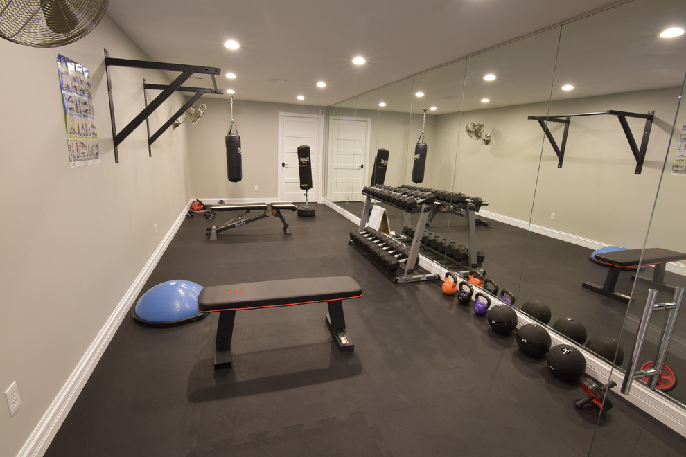 Home weight room - mid-sized transitional vinyl floor and black floor home weight room idea in St Louis with beige walls