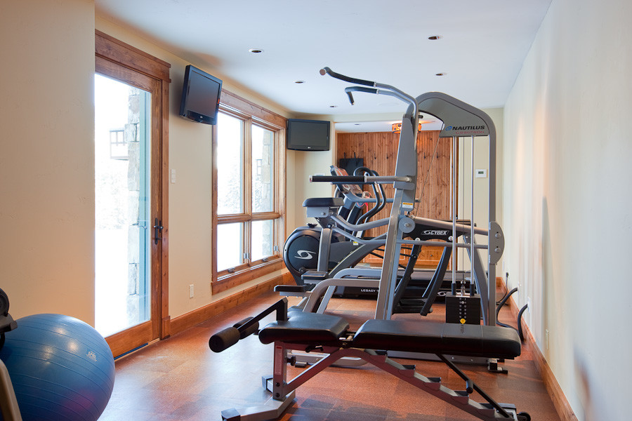 Multiuse home gym - mid-sized rustic cork floor multiuse home gym idea in Denver with beige walls