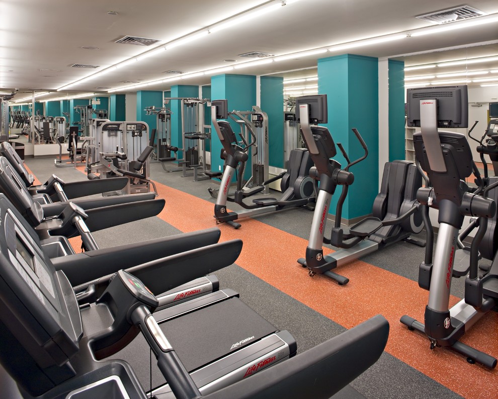 Inspiration for a large contemporary home weight room remodel in New York with green walls