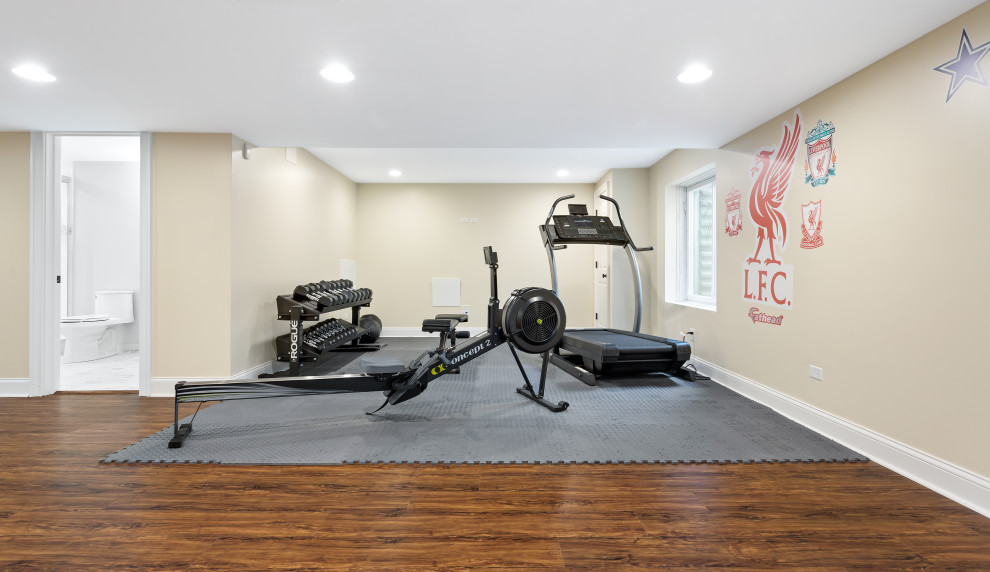 Inspiration for a mid-sized contemporary medium tone wood floor multiuse home gym remodel in Chicago with beige walls