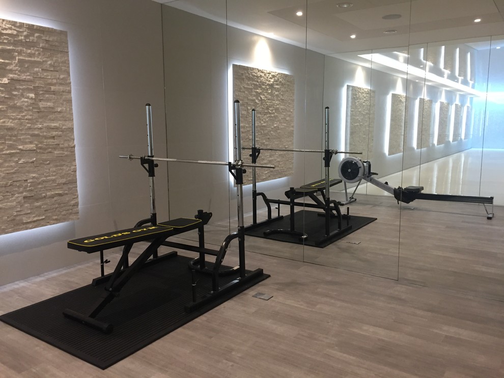 Photo of a large contemporary home gym in Surrey with beige walls, vinyl flooring and beige floors.