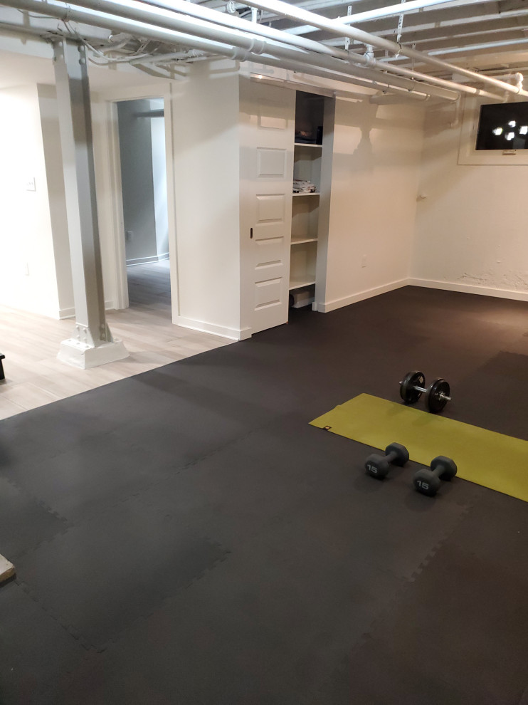 Contemporary multi-use home gym in DC Metro with white walls.