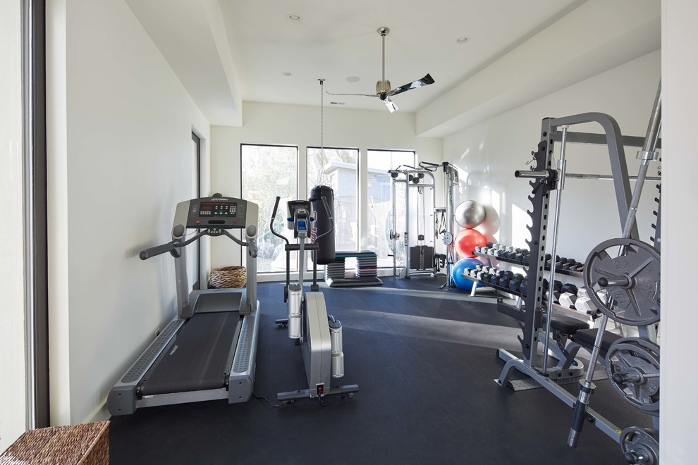 Inspiration for a mid-sized home weight room remodel in Charlotte with white walls
