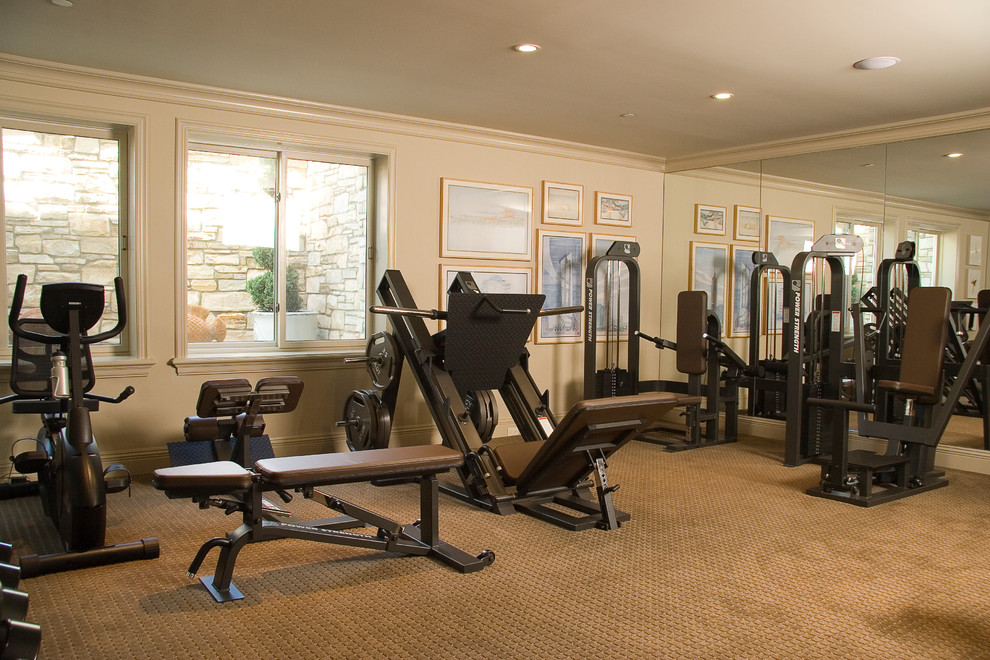 Design ideas for a large traditional home weight room in Los Angeles with beige walls and carpet.