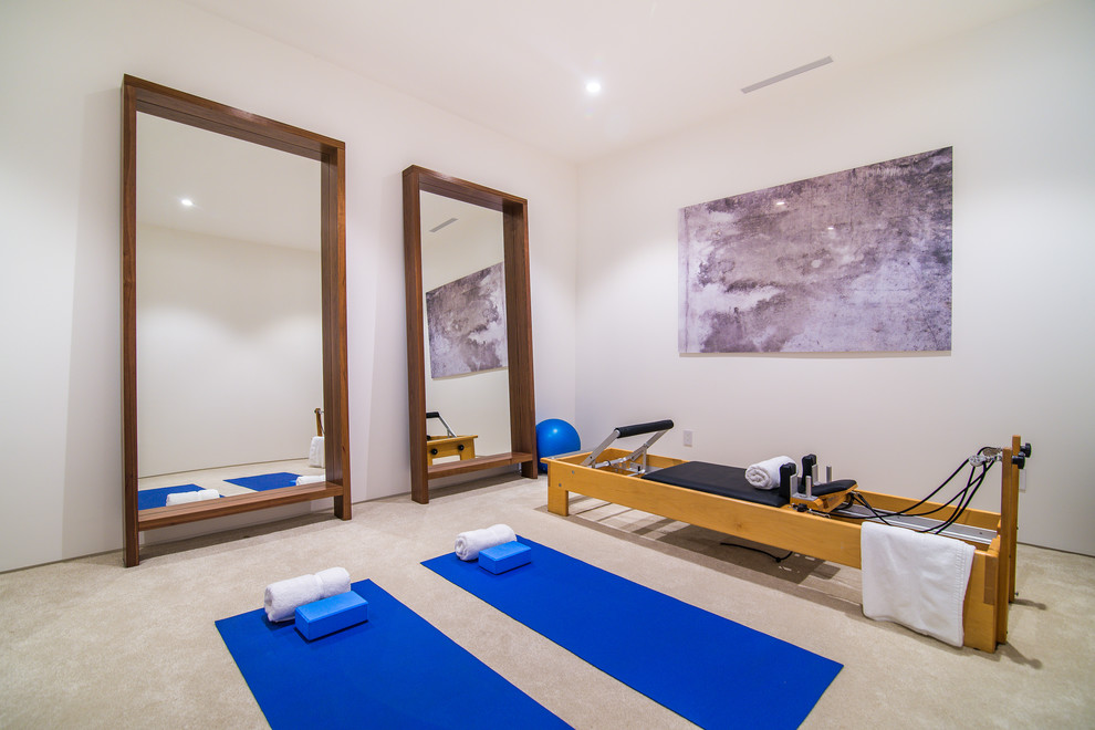 Medium sized contemporary home yoga studio in Los Angeles with white walls, porcelain flooring and beige floors.