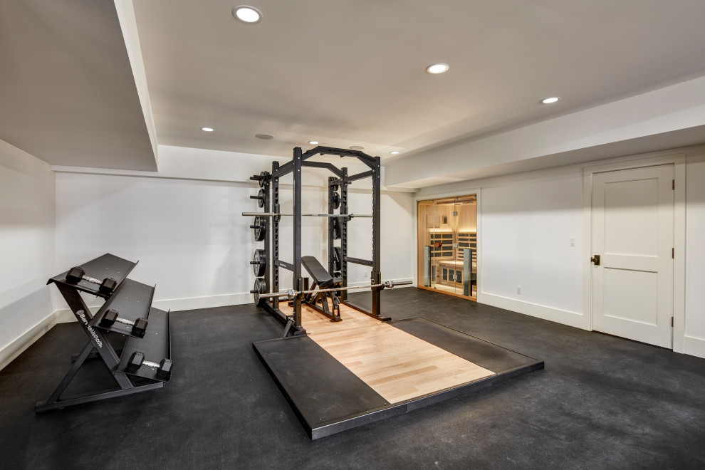 Large trendy black floor home weight room photo in Detroit with white walls