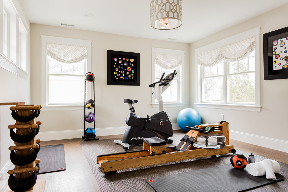 Medium sized traditional multi-use home gym in Boston with beige walls, brown floors, medium hardwood flooring and feature lighting.