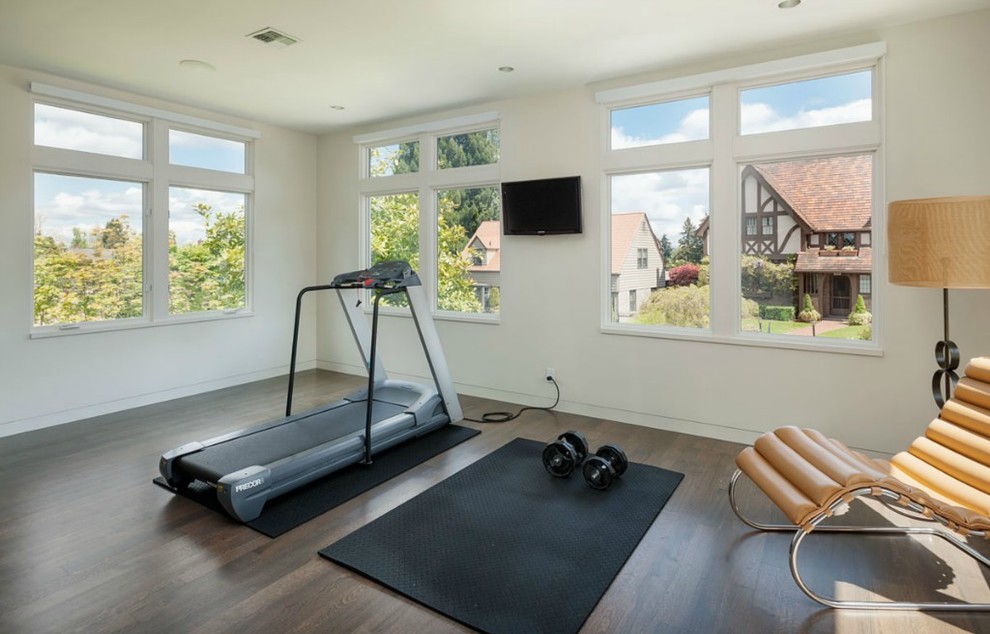 Medium sized modern multi-use home gym in Seattle with beige walls and dark hardwood flooring.